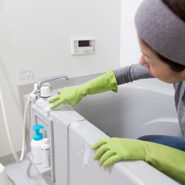 Person cleaning bathtub