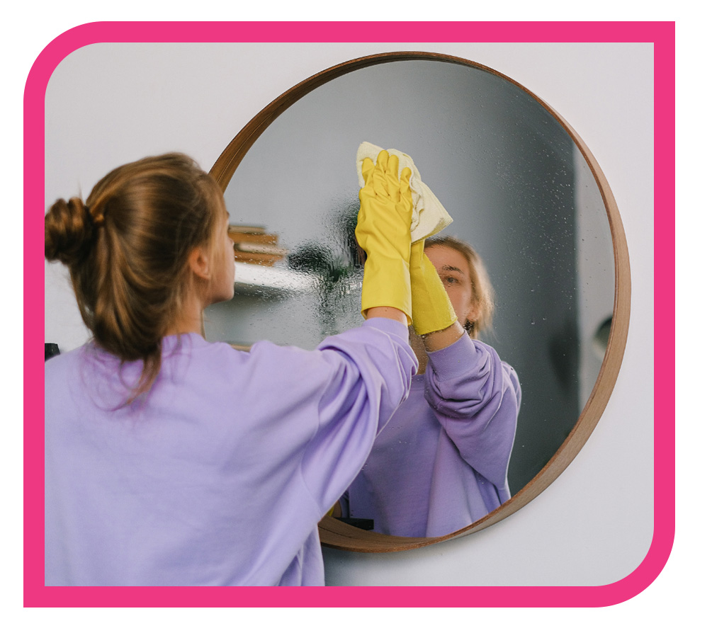 woman cleaning mirror