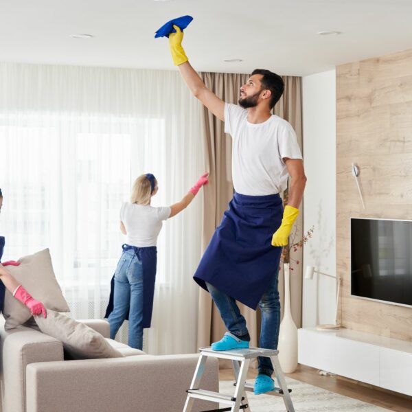 cleaners dusting living room